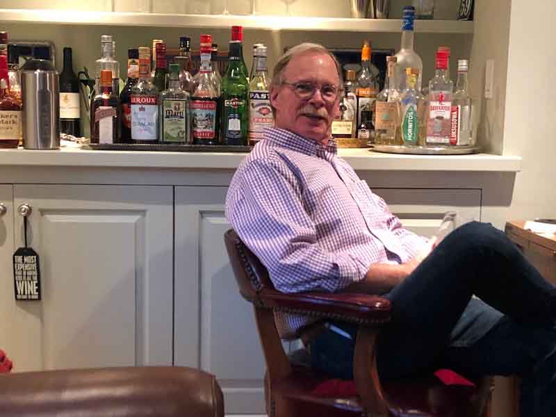 man sitting a chair at a table