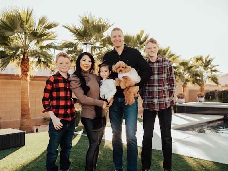 family standing on a lawn