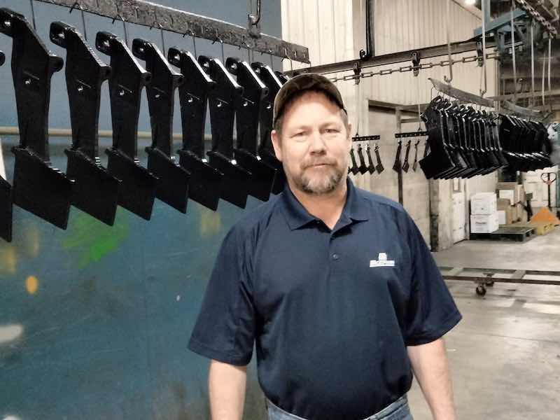 man standing in front of powder coating line