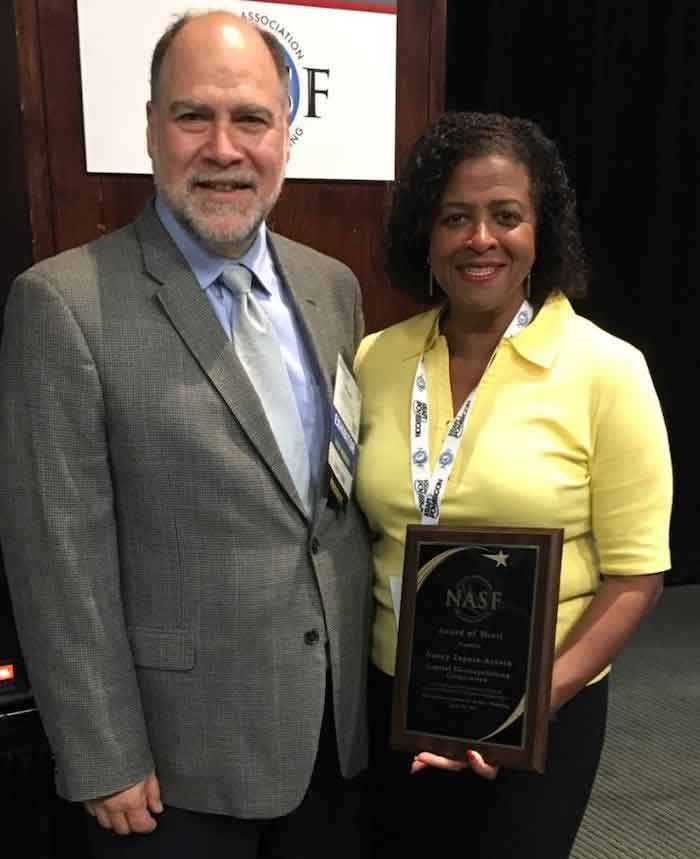 Nancy Zapata-Acosta received the NASF Award of Merit from association president Paul Brancato, Vice President of Epner Technology.