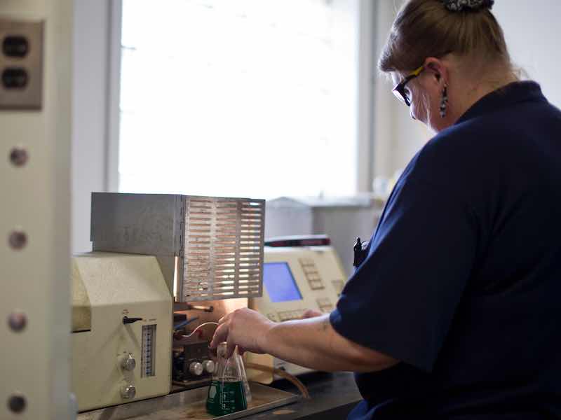 A Reliable Plating Works staff members tests the wastewater system at the plant.