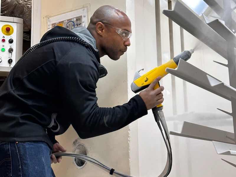 man applying powder coating
