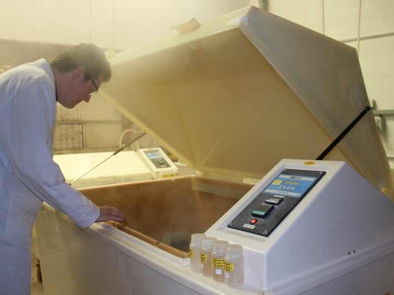 man looking into salt spray chamber
