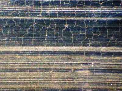 "Chicken cracks" caused by excessive grinding pressure and/or insufficient lubrication.