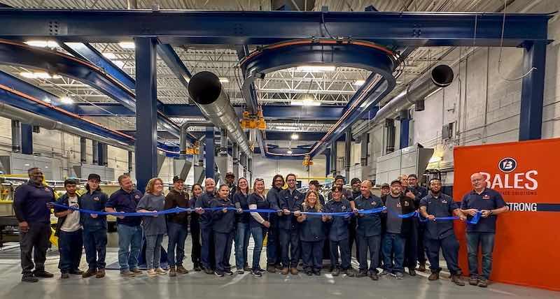 Bales' team members gather for the new nickel lines' ribbon cutting.