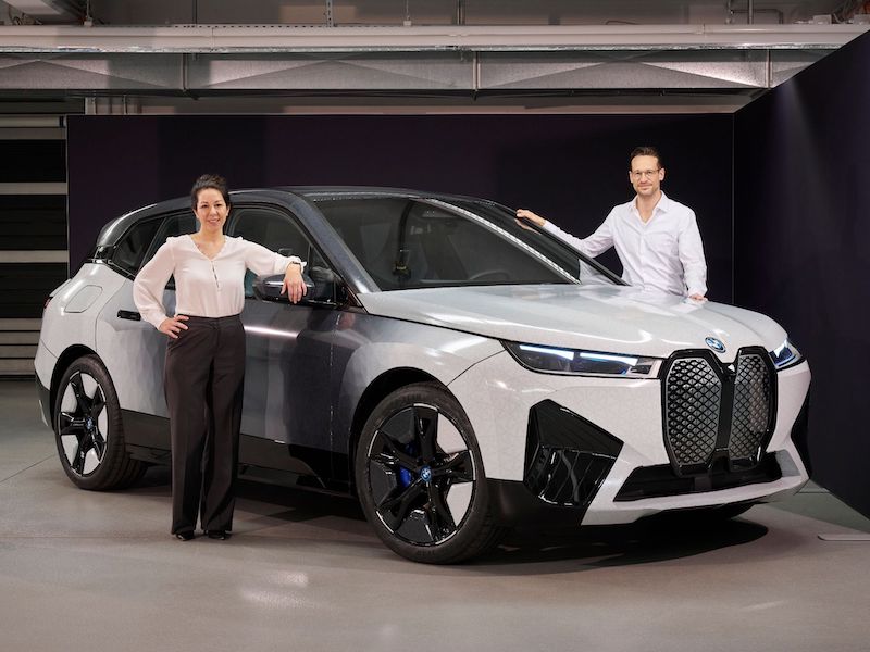 two people standing near a car