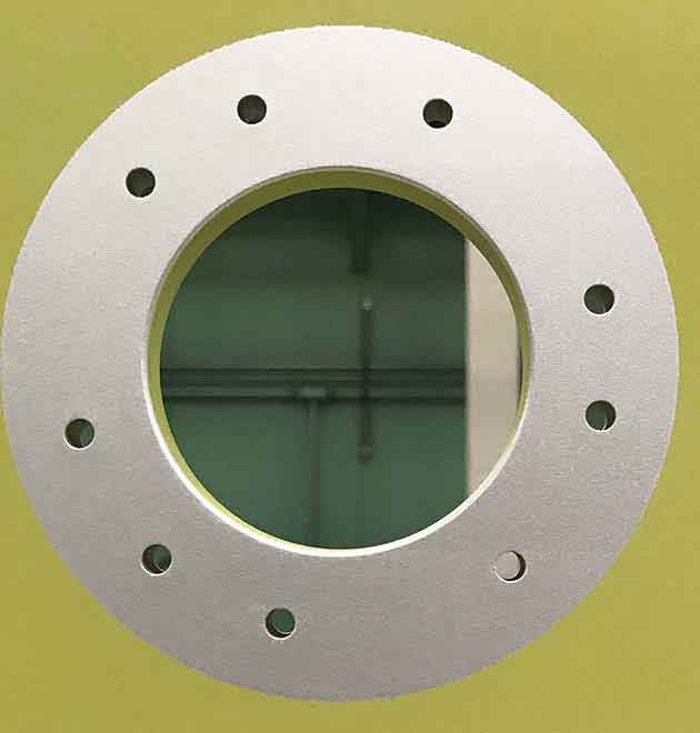 LASER FOCUSED: Laser ablation removed the yellowish-green paint in a tight circle on this aluminum aircraft part. Photo: Kady Gregersen