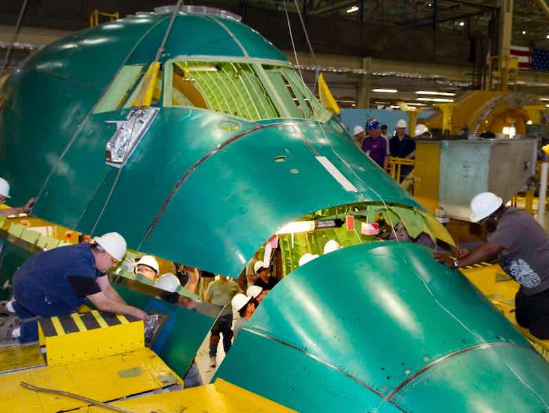 people working on airplane parts