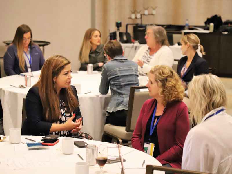 women taking at tables