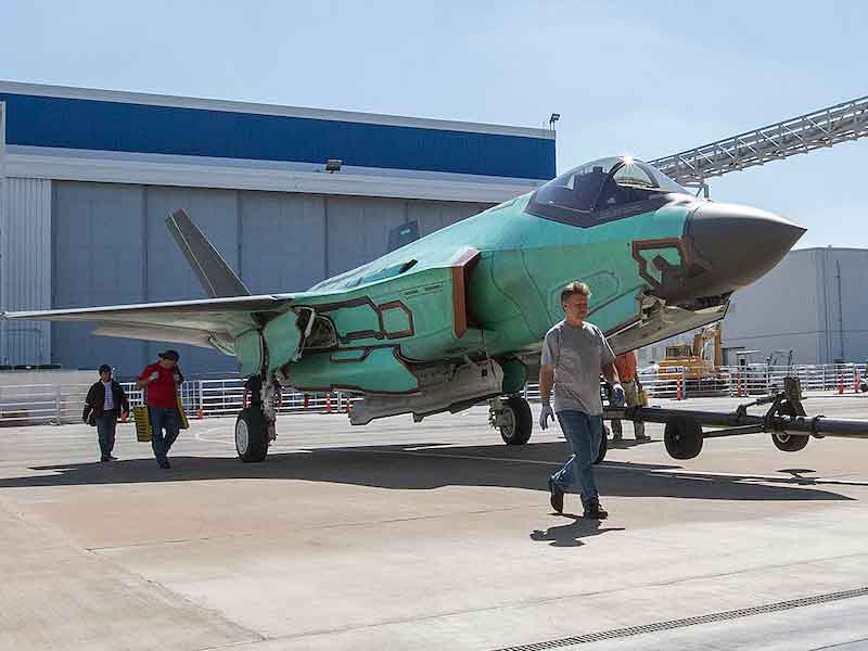 an airplane being moved to be painted