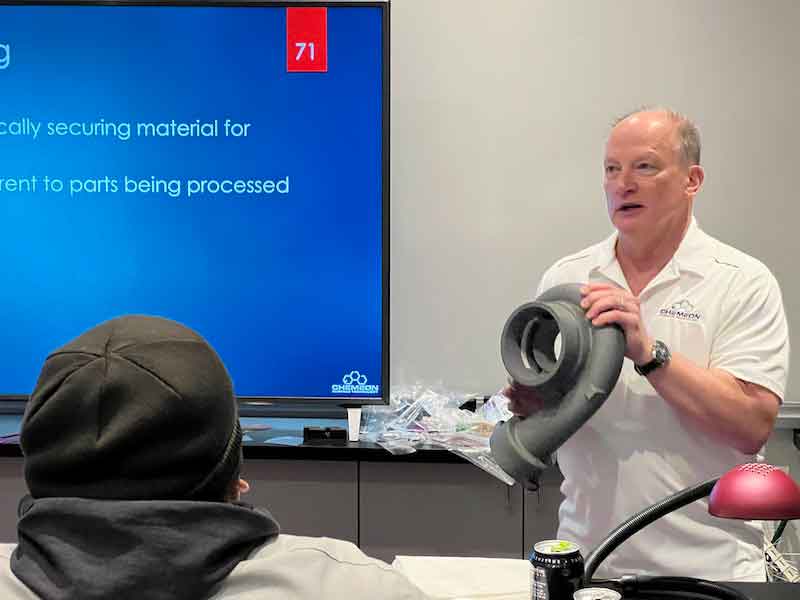 Dr. Westre shows several parts that have been anodized. 