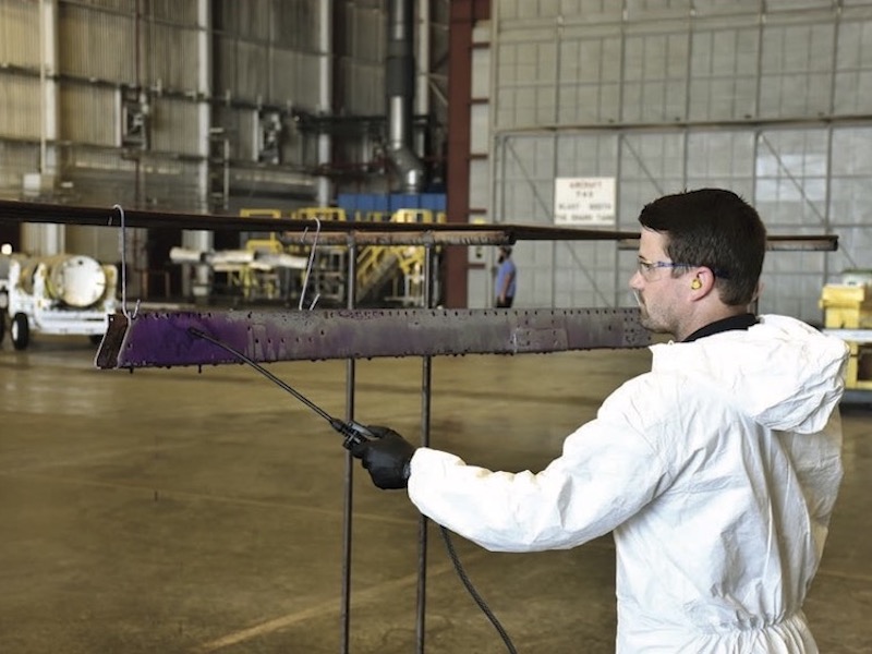 Peter Sheridan applies eTCP to aircraft missile launcher at FRC Southeast as part of this NESDI projectâs demonstration and validation. (Photo Credit: Joe Santa Maria)