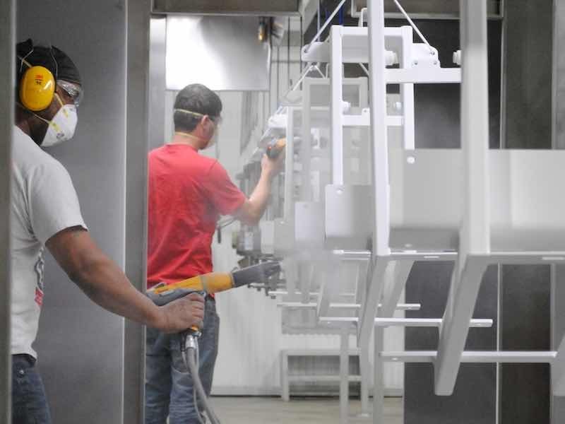 two men powder coating parts