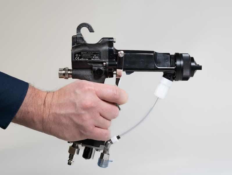 person holding spray gun