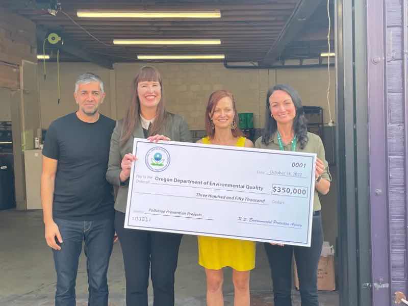 people holding grant check