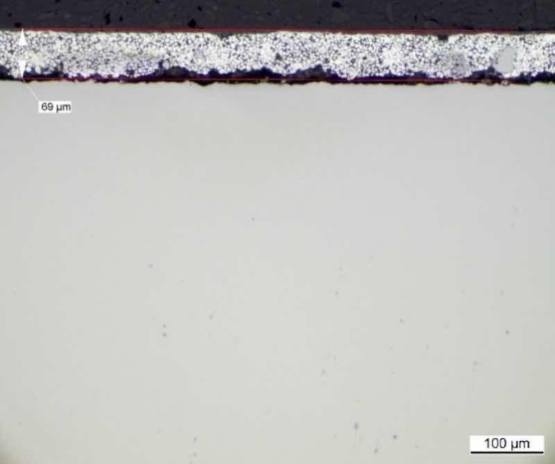 Figure 4 Microstructure of the sacrificial aluminum-ceramic coating with visible imperfections, scratches and decohesion, sample ground with too much pressure, and in the direction opposite to the adhesion of the coating to the base material - incorrectly prepared in an external laboratory.