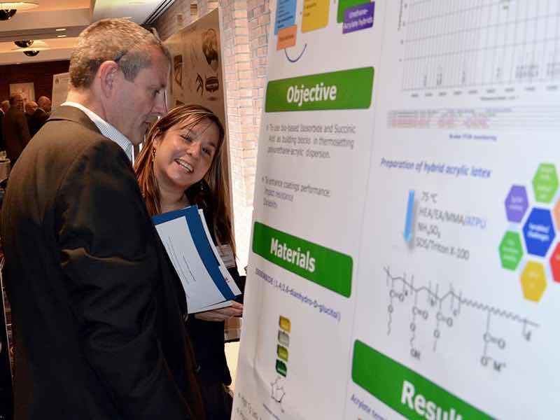 two people looking at poster