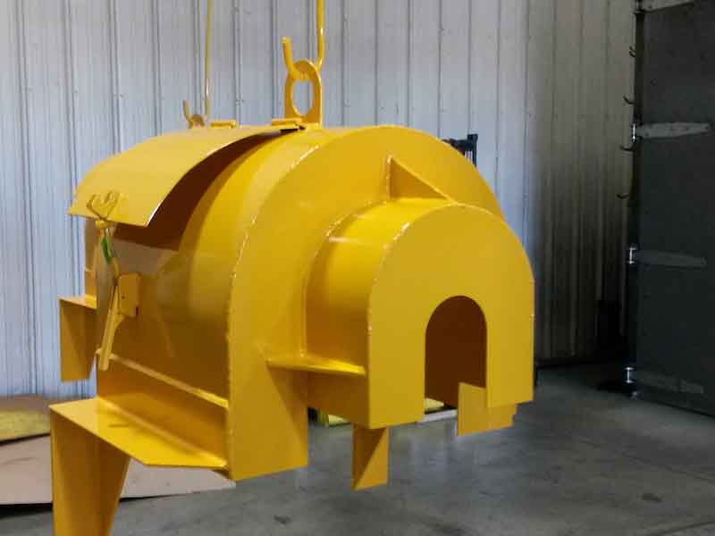 a yellow coated part hangs from a pole