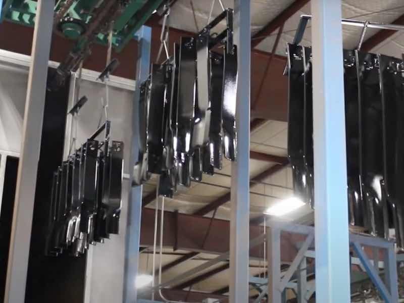 parts hanging on powder coating line