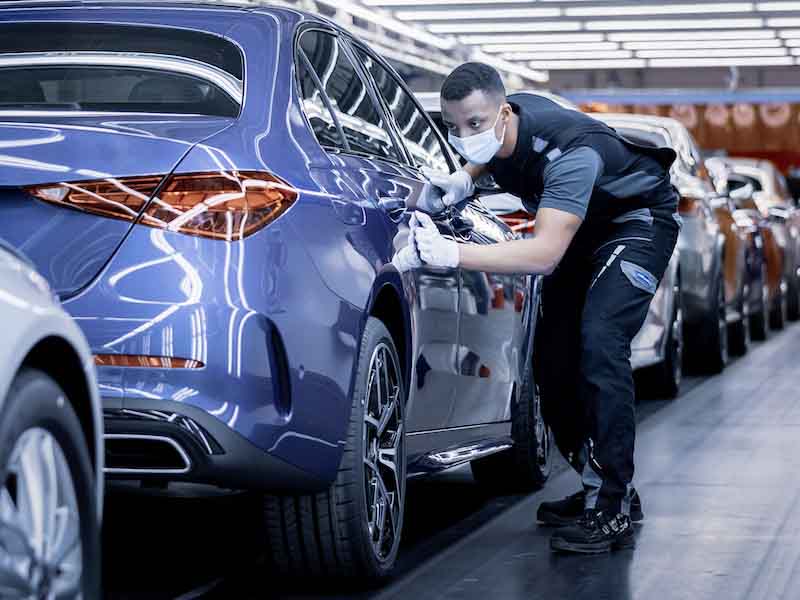 man looking at car surface