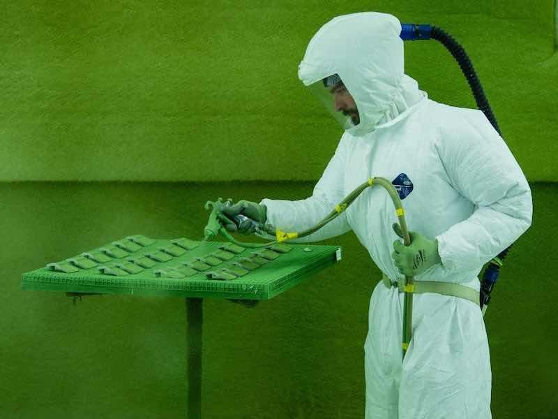 person sparing paint on parts