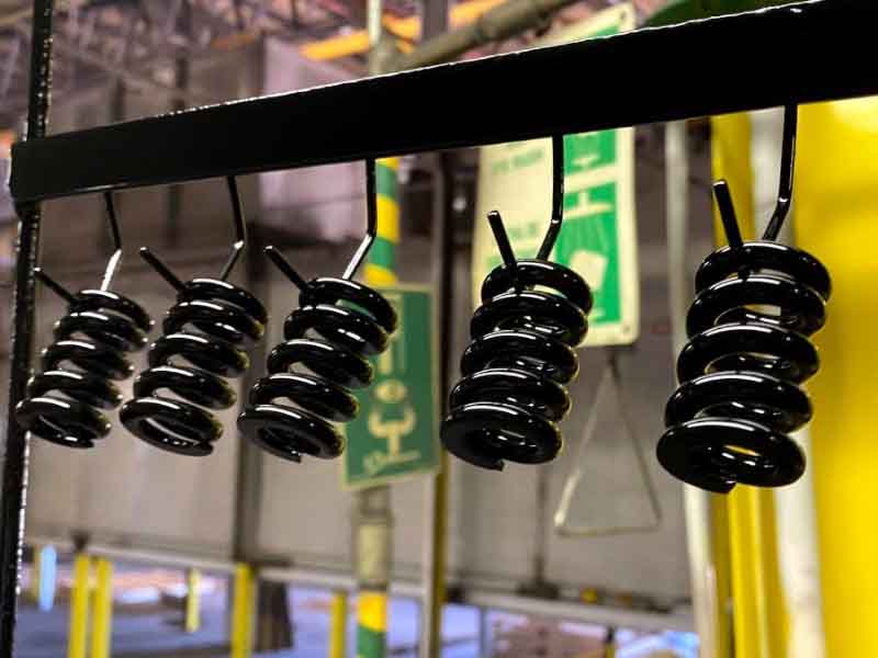 powder coated parts handing from a line