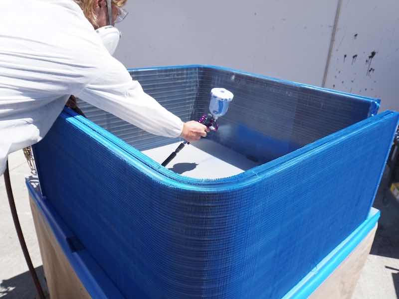 man spraying parts