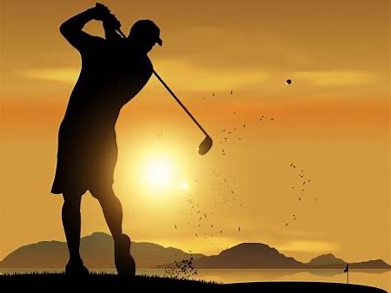man hitting a golf ball