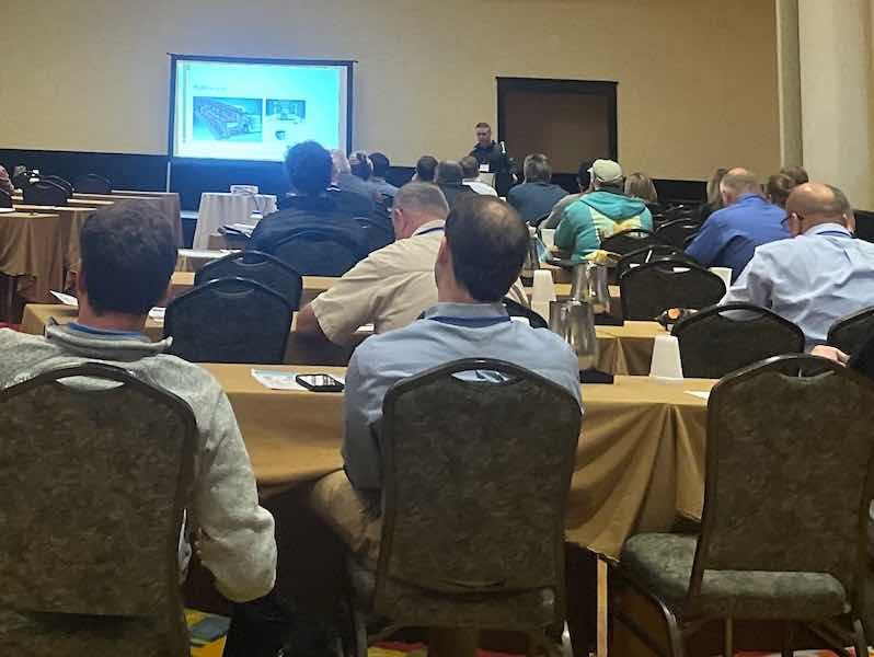 speaker in a room of attendees