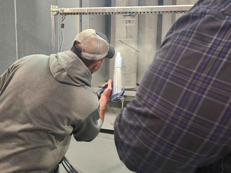 man applying powder coating