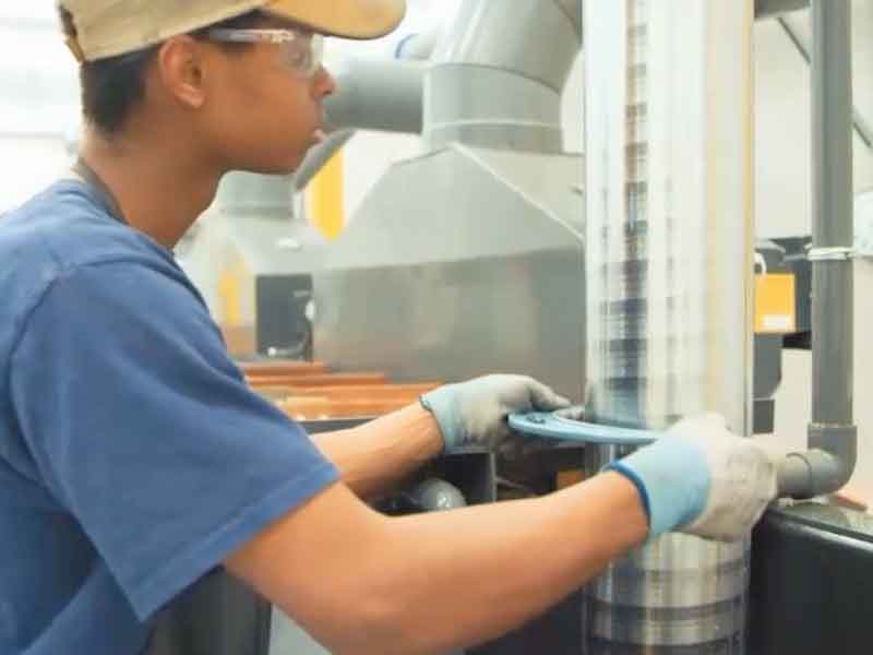 A technician at Carter Machinery checks the final chrome coating.