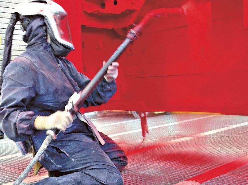 man painting with powder coating
