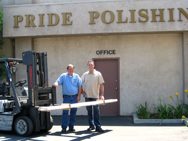 two men standing in front of shop