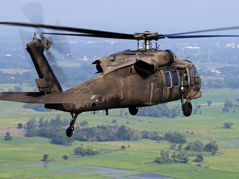 helicopter flying through a valley