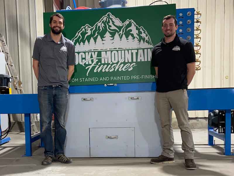 two men standing in front of a sign