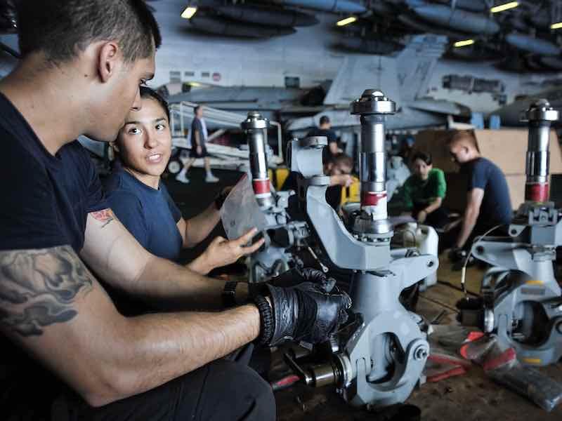 airplane mechanics working on parts