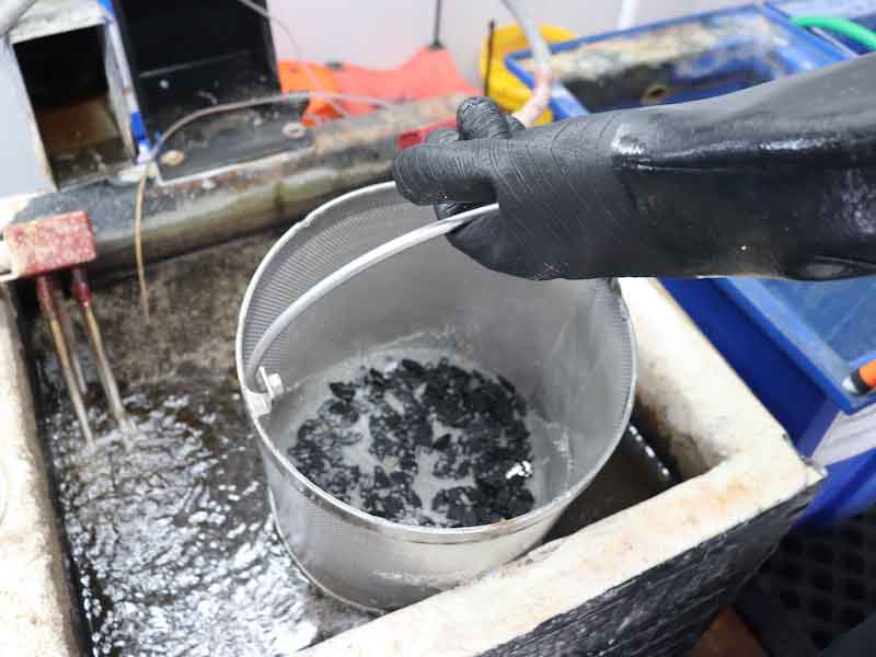 parts in a basket being cleaned