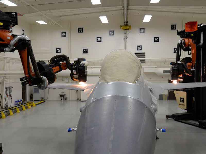 plane being depainted by robots
