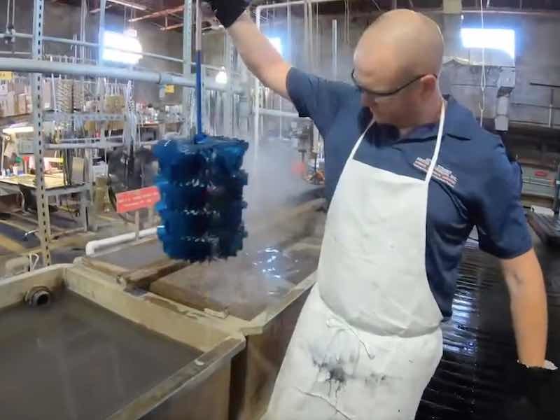 man pulling parts from tank