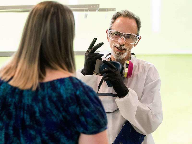Daniel Haistings, who is deaf, and Human Resource Manager Jasmin Baker-Kinney use American Sign Language at Valence Surface Technologies in Everett. (Andy Bronson / The Herald)