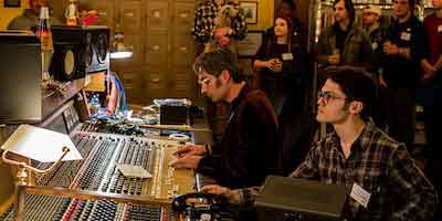 Chris Mara mans the control board at Welcome to 1979 Studios