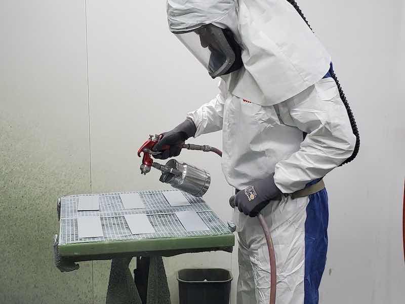 person spraying paint
